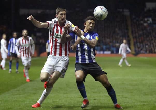 Sheffield United's Chris Basham (left) and Sheffield Wednesday's Liam Palmer battle in last week's derby. Picture: Simon Cooper/PA