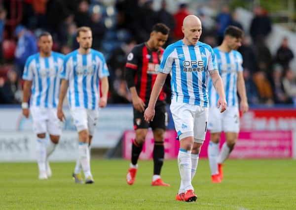 Huddersfield Town's Aaron Mooy leaves the pitch.