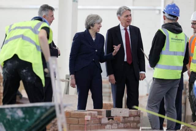 Theresa May and  Philip Hammond during a visit to Leeds College of Building after the 2017 Autumn Statement - but does the Government lack foundations for the future?