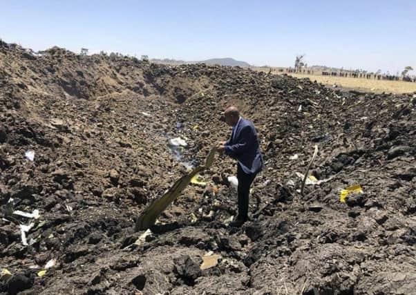 The CEO of Ethiopian Airlines, Tewolde Gebremariam, looks at the wreckage of the plane that crashed shortly after takeoff from Addis Ababa.