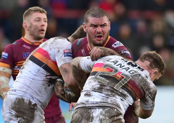 Batley's James Brown is tackled by the Bradford defence.