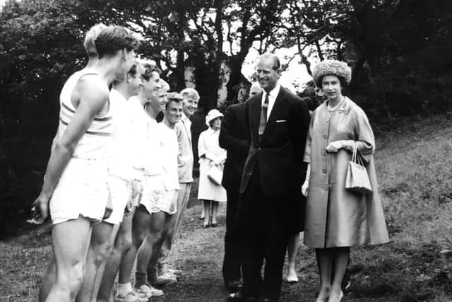 The Duke of Edinburgh and the Queen meeting participants in an Outward Bound activity.