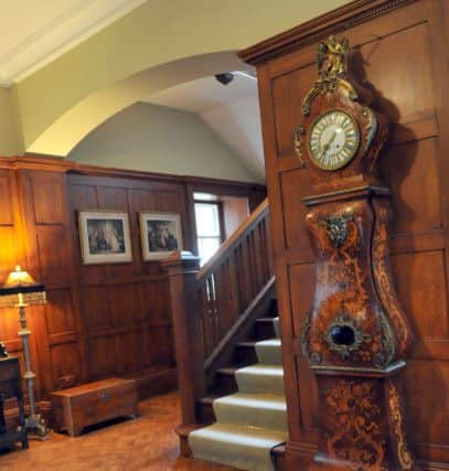 The hall with its wood panelling and a staircase that are typical of the Arts and Crafts era.