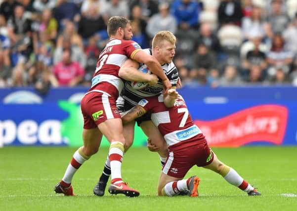 Hull FC's Brad Fash, seen being tackled by Wigan Warriors' Sean O'Loughlin  and Sam Powell, has joined Toronto Wolfpack on loan (Picture: Dave Howarth/PA Wire).