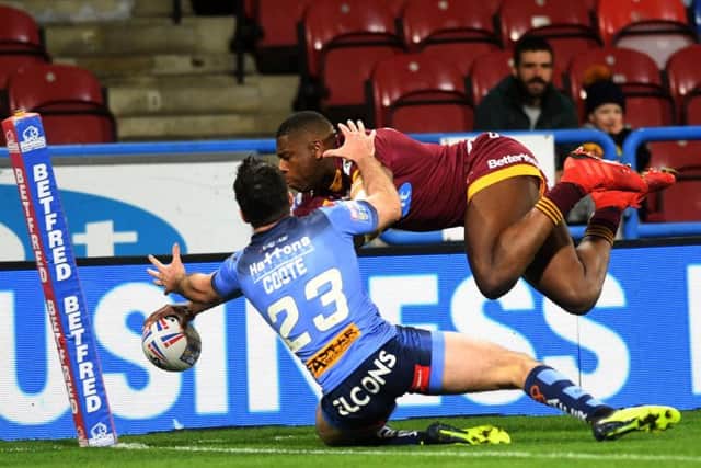 England winger Jermaine McGillvary goes over for Huddersfield Giants' first try against St Helens. (PIC: Jonathan Gawthorpe)