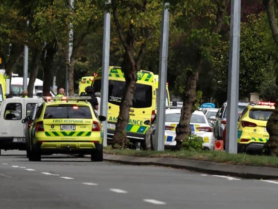 Ambulances parked outside a mosque in central Christchurch, New Zealand, Friday, March 15, 2019. Many people were killed in a mass shooting at a mosque in the New Zealand city of Christchurch on Friday, a witness said. Police have not yet described the scale of the shooting but urged people in central Christchurch to stay indoors. (AP Photo/Mark Baker)