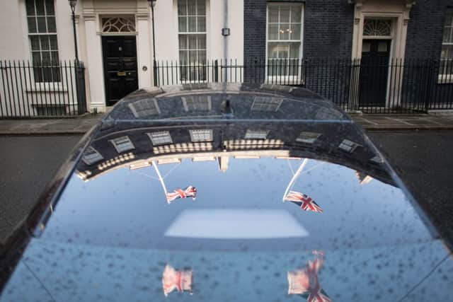 Flags are reflected on the Prime Minister Theresa May's car parked in Downing Street.