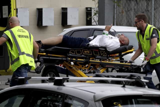 Ambulance staff help a victim of the mass killings in Christchurch.