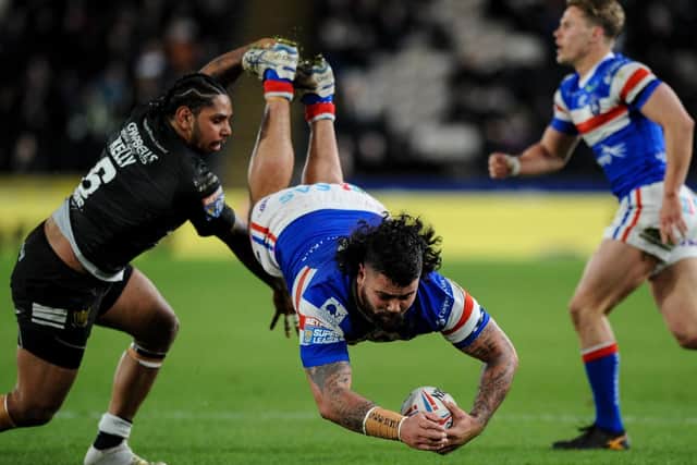 Wakefield's David Fifita is upended by Hull's Albert Kelly (PIC: Dean Williams)