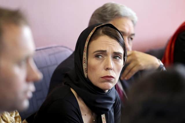In this photo released by New Zealand Prime Minister's Office, Prime Minister Jacinda Ardern, center, meets representatives of the Muslim community, Saturday, March 16, 2019 at the Canterbury Refugee Centre in Christchurch, New Zealand. New Zealand's prime minister says the "primary perpetrator" in the killing of at least 49 people in two Christchurch mosques was living in Dunedin, a seaside city south of Christchurch.