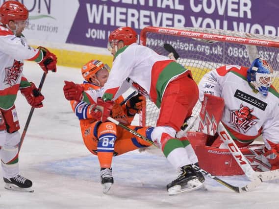 TAKE THAT: Sheffield Steelers' Tom Zanoski is taken to the ice by a Cardiff defender in January's meeting between the two at Sheffield Arena. Picture: Dean Woolley.