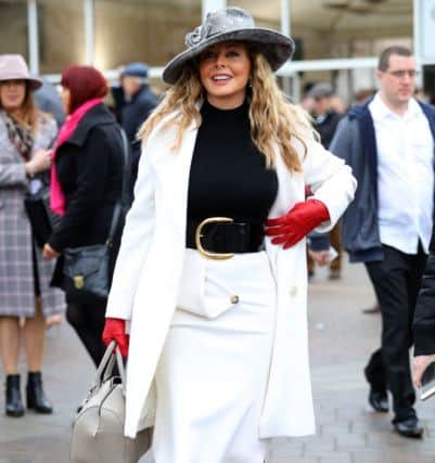 Monochrome look champions the skirt. Carol Vorderman during Gold Cup Day of the 2019 Cheltenham Festival at Cheltenham Racecourse. Aaron Chown/PA Wire.