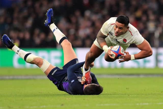 England's Manu Tuilagi is just caught by Scotland's defence. (Gareth Fuller/PA Wire)