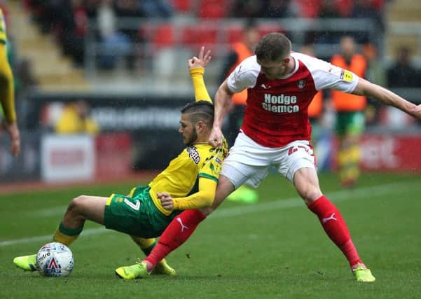 Battling: Rotherham United's Michael Smith challenges Norwich City's Emi Buendia.