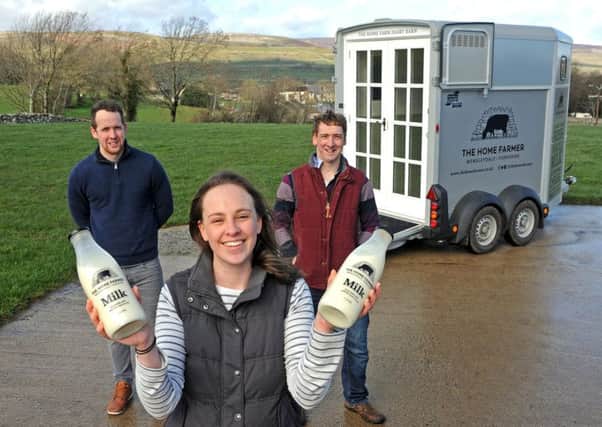 Aysgarth dairy farmers Ben, right, and Samantha Spence and Ben's brother Adam Spence, left,  have converted a horse box into a mobile shop containing a vending machine, from which customers can pour fresh whole milk into glass bottles. The horsebox will be parked up at villages across Wensleydale. Picture Tony Johnson.