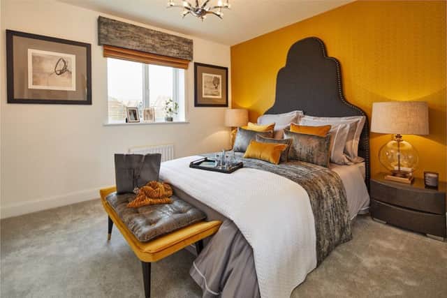 The master bedroom with fashionable ochre coloured walls.