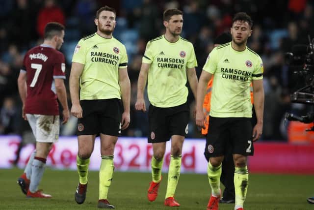 Jack O'Connell, Chris Basham and George Baldock leave the field frustrated after Sheffield United drew 3-3 at Aston Villa. (Picture: Simon Bellis/Sportimage)