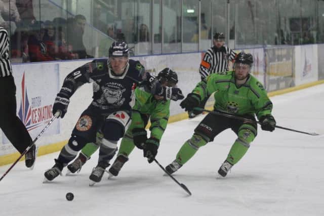 Sheffield Steeldogs' Nathan Salem , left, battles for possession against Hull Pirates during Sunday's title showdown at Ice Sheffield. 

Picture: Cerys Molloy.
