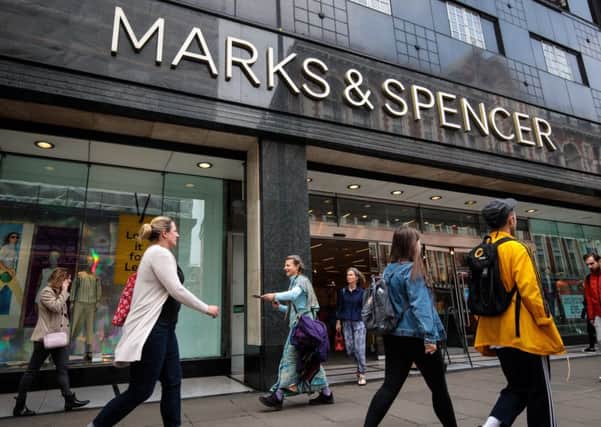 Shoppers walk past a Marks and Spencer (M&S) store on Oxford Street   (Photo by Jack Taylor/Getty Images)