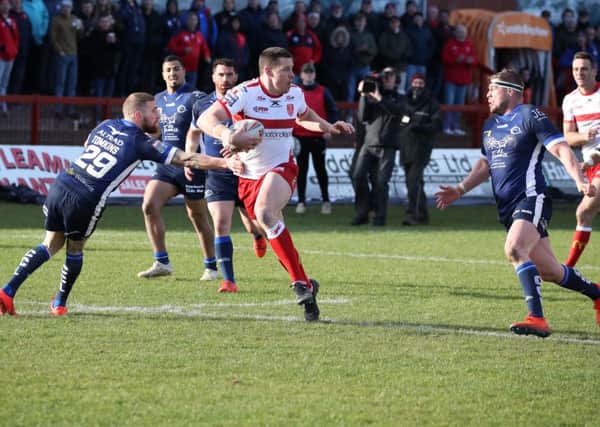 Brother baffled: Hull KR's Joel Tomkins goes past brother Sam to score against Catalans. Picture: Hull KR