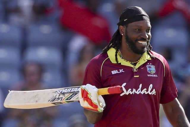 West Indies' Chris Gayle celebrates after he scored a century against West Indies during the fourth One Day International cricket match at the National Stadium in St. George's, Grenada. (AP Photo/Ricardo Mazalan)