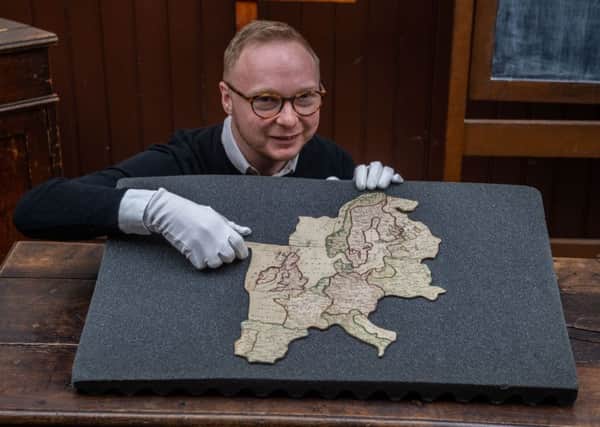Phillip Newton, Communities Engagement Researcher at York Castle Museum with the rare 18th Century jigsaw map of Europe.
