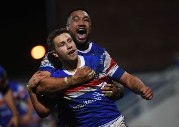 In at the double: Wakefield's Kyle Wood celebrates his second try with Tinirau Arona. 
Picture: Jonathan Gawthorpe