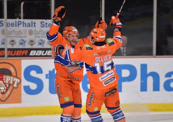 Jonathan Phillips celebrates his goal against Cardiff Devils last Saturday with line-mate Anthony DeLuca - who scored the other four. Picture: Dean Woolley.