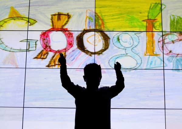 Darragh Brady from Edmondstown National School in Dublin in front of his doodle on stage at Google offices in Dublin after he won the Junior category  in the 'Doodle for Google' competition. PRESS ASSOCIATION Photo. Picture date: Monday March 12, 2012. See PA story TECHNOLOGY Google Ireland. Photo credit should read: Julien Behal/PA Wire