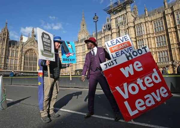 Protestors both for and against Brexit face off outside Westminster in London. Picture: Jonathan Brady/PA Wire