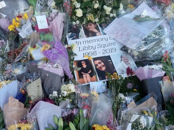 Floral tributes laid under the tree of remembrance in the University grounds