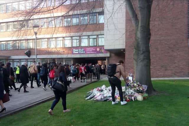 Students laid more flowers at the foot of the remembrance tree as they left the event