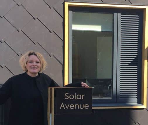 Katrina Welsh, one of the first Climate Innovation District residents, outside her new house.