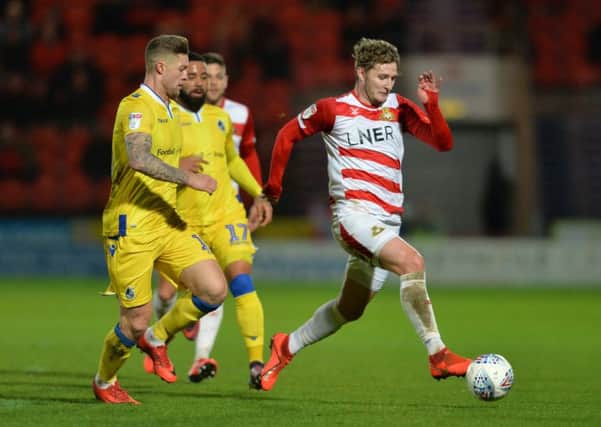 Doncaster's Kieran Sadlier goes past Bristol Rovers' James Clarke during Tuesday night';s League One Clash at the Keepmoat which Rovers won 4-1. Picture: Bruce Rollinson