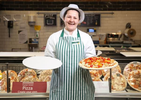 Customer assistant Emilia Sliwinska displays a new cardboard tray for pizzas, as Morrisons announces that it will be completely removing polystyrene from all own-brand food and drink products nationwide, at Morrisons Colindale in London.  Photo: Matt Alexander/PA Wire