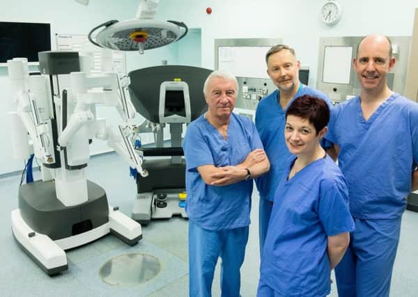 Dave Allen, David Reynolds, Jim Catto, Kirsten Major with the new surgical robot.