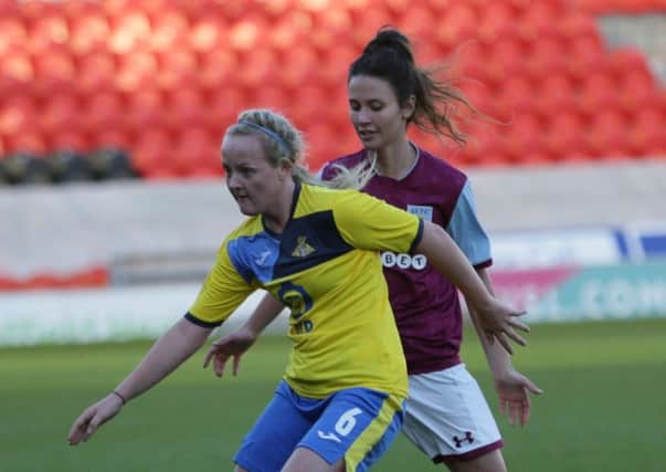 Chloe Peplow (yellow) in action for Doncaster Rovers Belles vs Aston Villa.
