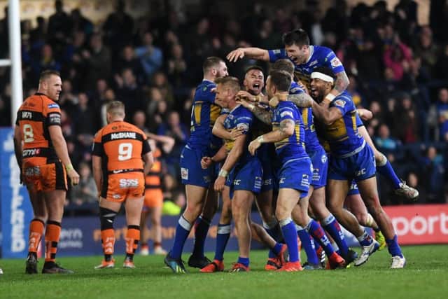 Leeds Rhinos' Brad Dwyer is mobbed by team-mates after his Golden Point drop goal saw them beat Castleford Tigers in extra-time (
Picture: Jonathan Gawthorpe).