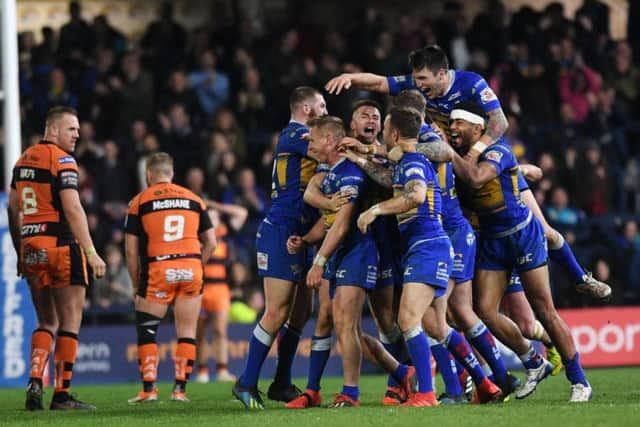 Leeds Rhinos players mob Brad Dwyer after his Golden Point extra-time drop goal winner against Castleford Tigers (PIC: Johnathan Gawthorpe)