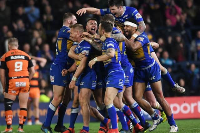Brad Dwyer is mobbed by team-mates after kicking Rhinos to victory (Picture: Jonathan Gawthorpe)