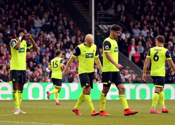 Going down: Huddersfield Town players show dejection.