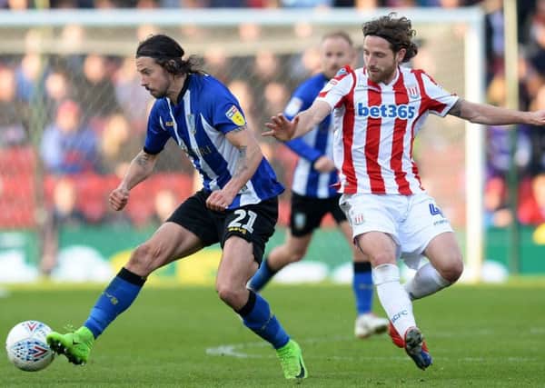 On the ball: George Boyd holds off City's Joe Allen.