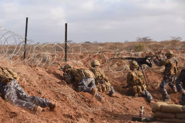 Soldiers from the 1st The Queen's Dragoon Guards playing the enemy, defending a forward operating base from an attack by 2 Rifles during Exercise Askari Storm in Kenya, as part of 2 Rifles preparations to deploy to Afghanistan next year. Picture by Robbie Hodgson/MoD/Crown Copyright/PA Wire.