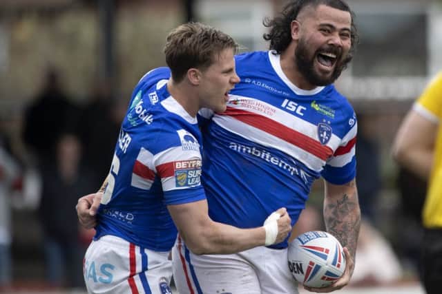 David Fifita, of Wakefield Trinity, celebrates the first try of the match, with team-mate Jacob Miller.