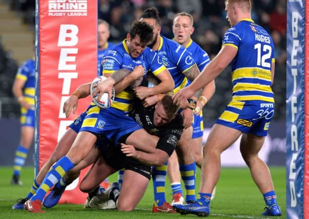 Joe Westerman is held up over the line during Hull's heavy defeat by Warrington.