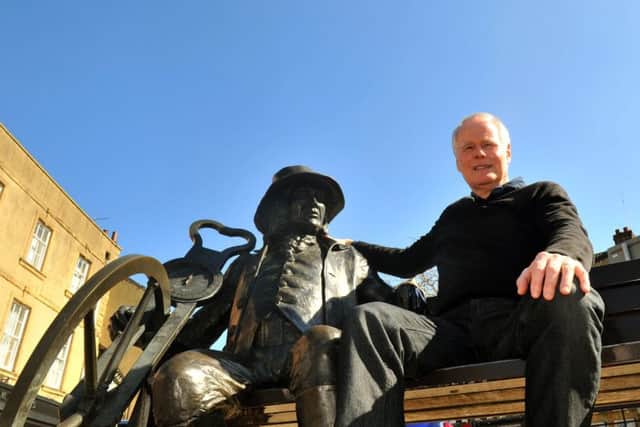 Bernard Higgins sits with the Blind Jack statue in Knaresborough.