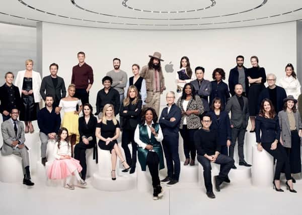 Reese Witherspoon, Oprah Winfrey, Jennifer Aniston and others with Apple's Tim Cook at the launch of its TV service.