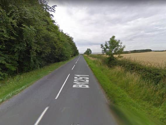 A man has died and a woman is in a serious condition in hospital after a motorbike and car crash on the B1251.