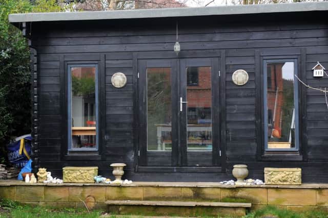 Rosie's studio is a timber garden chalet that came in kit form. She has painted it black.