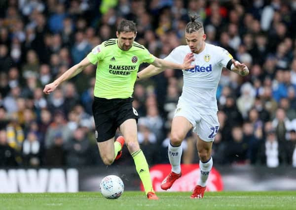 Sheffield United's Chris Basham, left, and Leeds United's Kalvin Phillips battle for the ball during last month's Championship match. The Blades and Whites are leading Yorkshire clubs' chase for automatic promotion but at least one may end up in the Wembley play-off final (Picture: Richard Sellers/PA Wire).